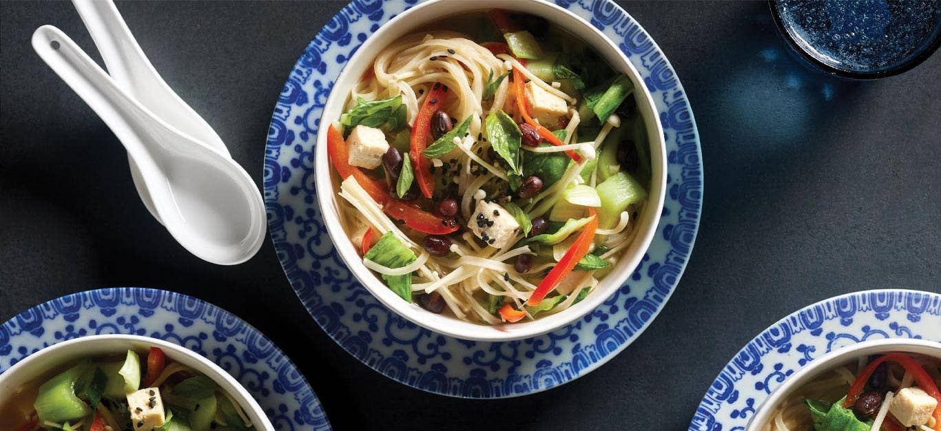 Rice Vermicelli Bowls with Bok Choy and Adzuki Beans in blue and white porcelain bowls with soup spoons