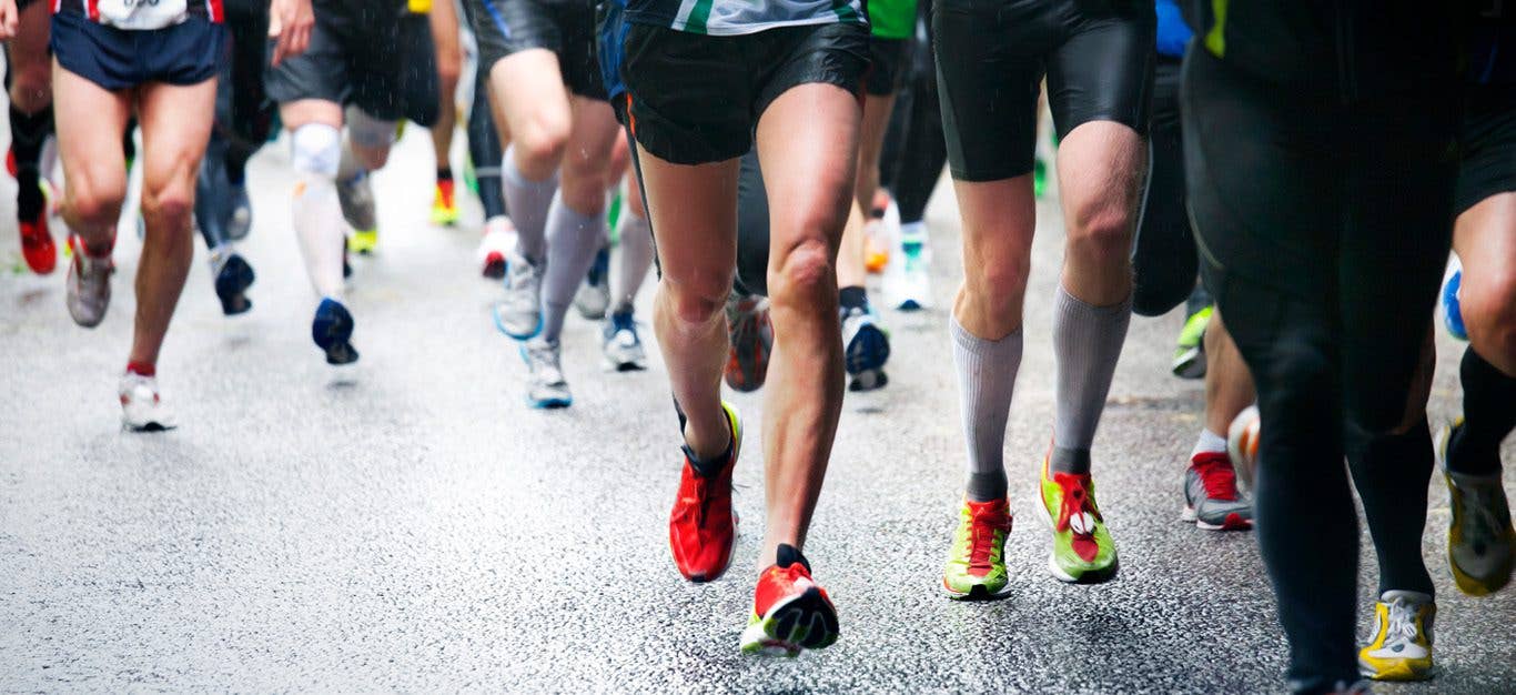 Legs and feet of a crowd of marathon runners in action