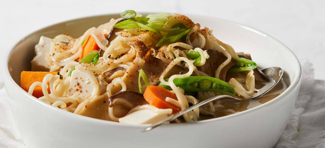 Creamy Vegan Ramen in a white bowl with a metal spoon