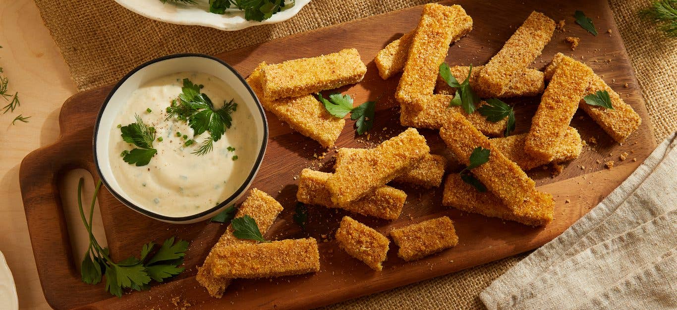 Crispy Baked Polenta Sticks with Ranch Dip on a wooden platter