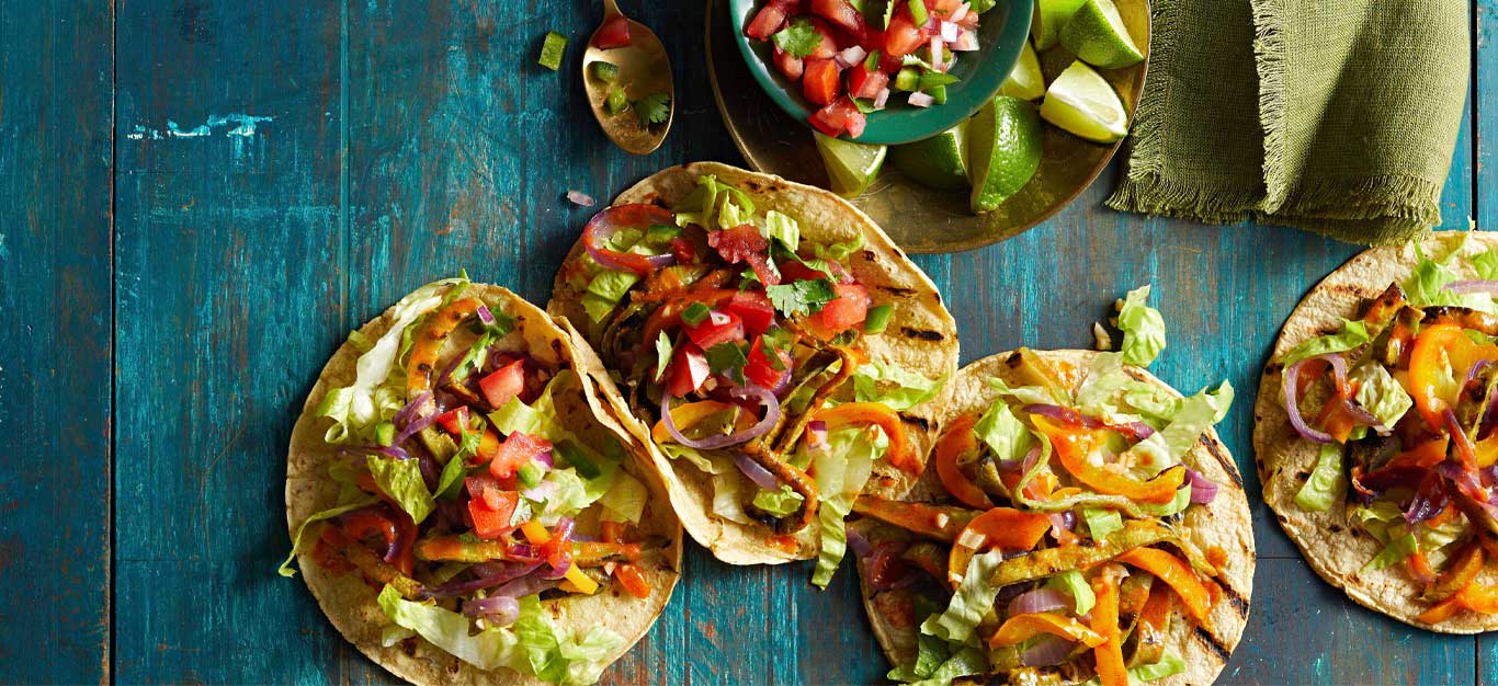 Grilled Nopales Tacos on a blue tabletop