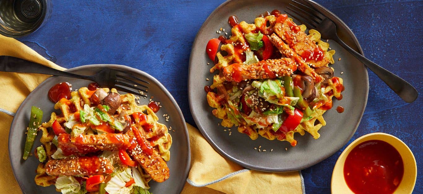 Vegan Korean-BBQ Waffles on grey plates on a blue table