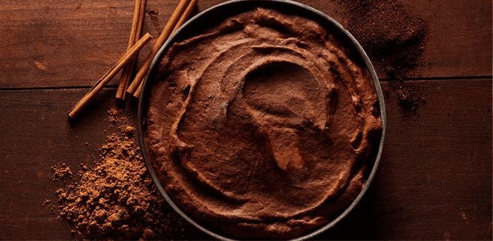 Dark Chocolate Ice Cream with cinnamon sticks next to bowl