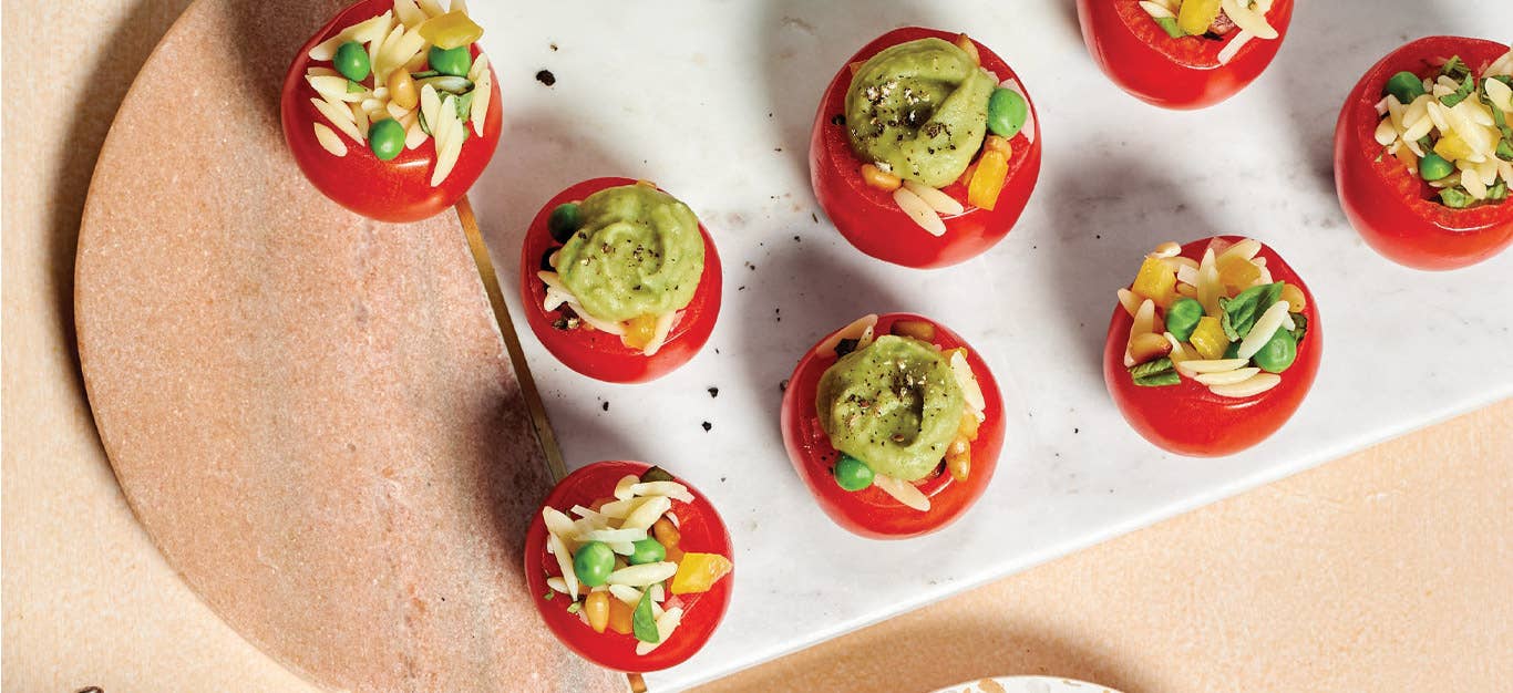 Orzo-Stuffed Tomatoes with Pesto Fluff on a white rectangular serving tray