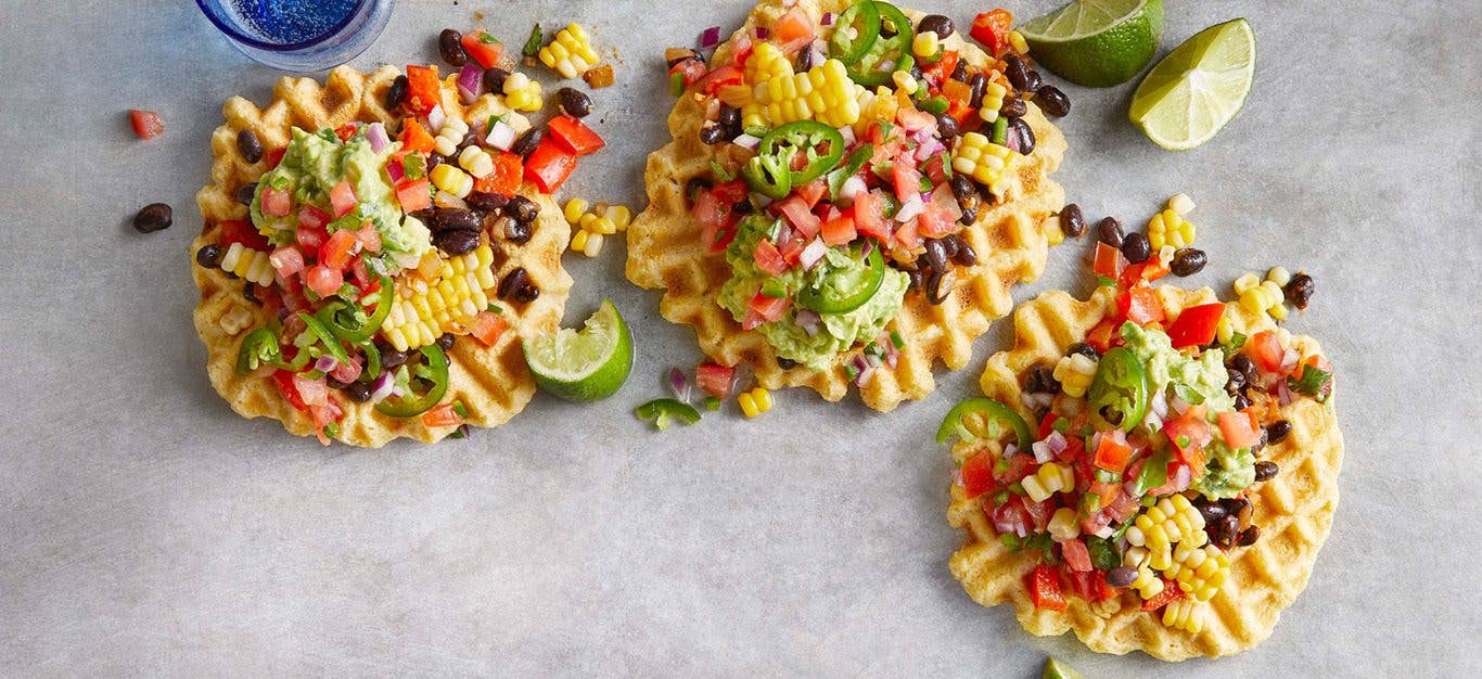 Tamale Waffles with Black Bean Hash on a grey countertop